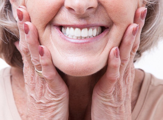 A woman smiling with dentures