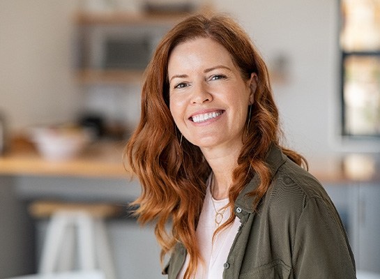 Closeup of woman with auburn hair smiling