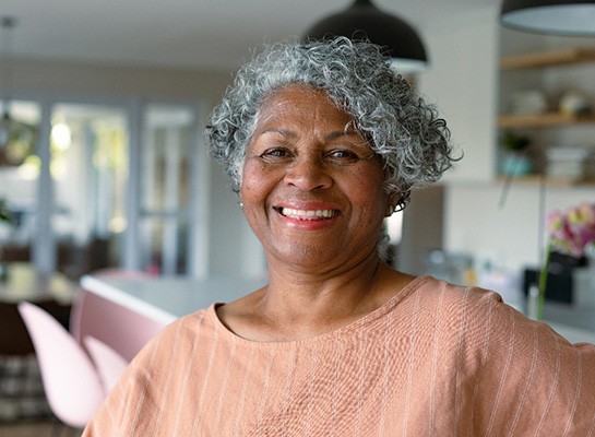 Closeup of senior woman smiling at home