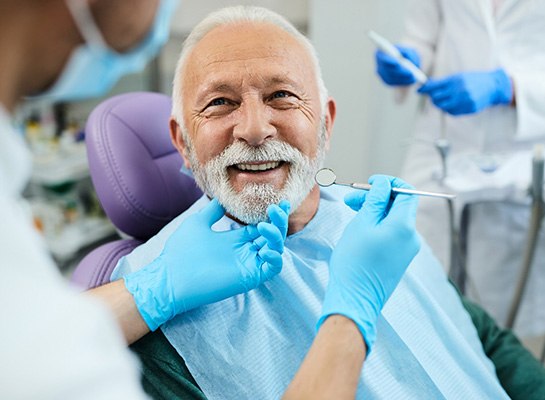 A man smiling at the dentist