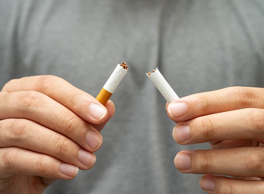 Closeup of patient breaking cigarette