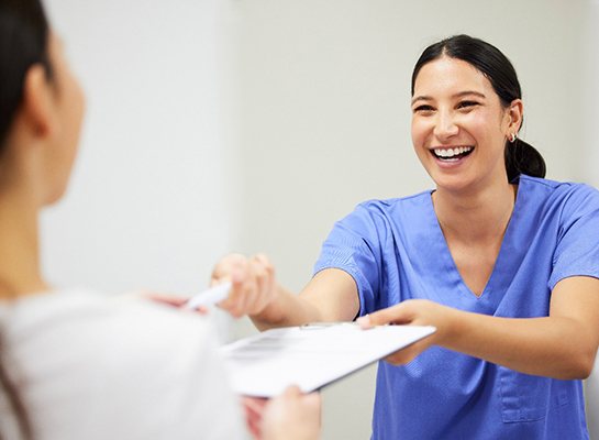 Patient in Hanover filling out paperwork for cosmetic dentistry