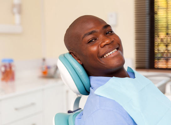 Smiling patient sitting in treatment chair