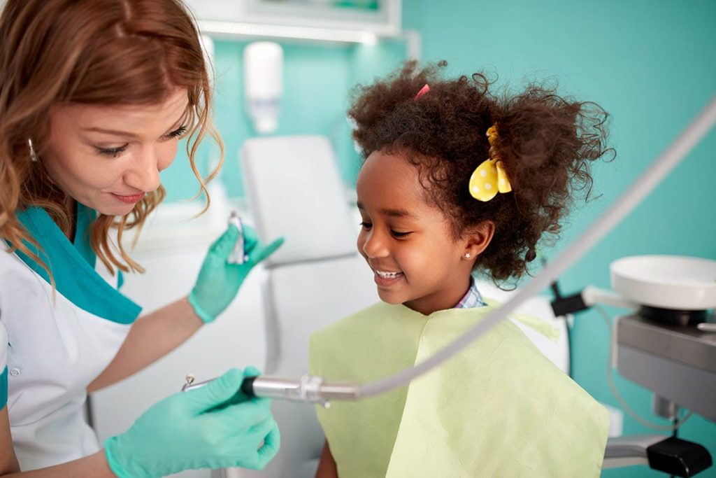 young girl at an appointment with her family dentist