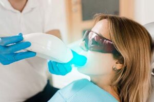 a patient is getting fluoride treatment services at the dentist